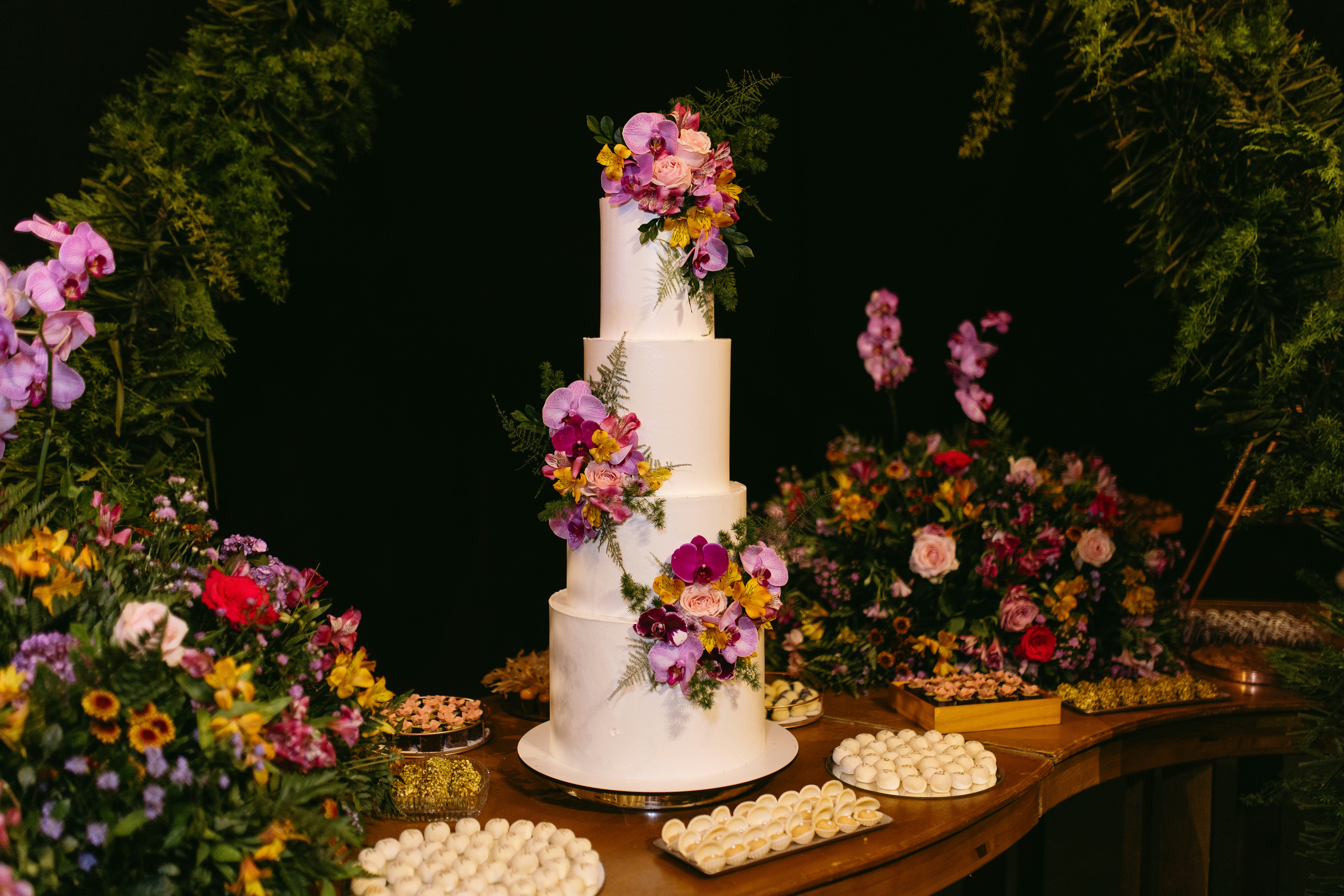 https://unsplash.com/photos/a-white-wedding-cake-surrounded-by-flowers-and-cookies-MrRPE-6FqQU
