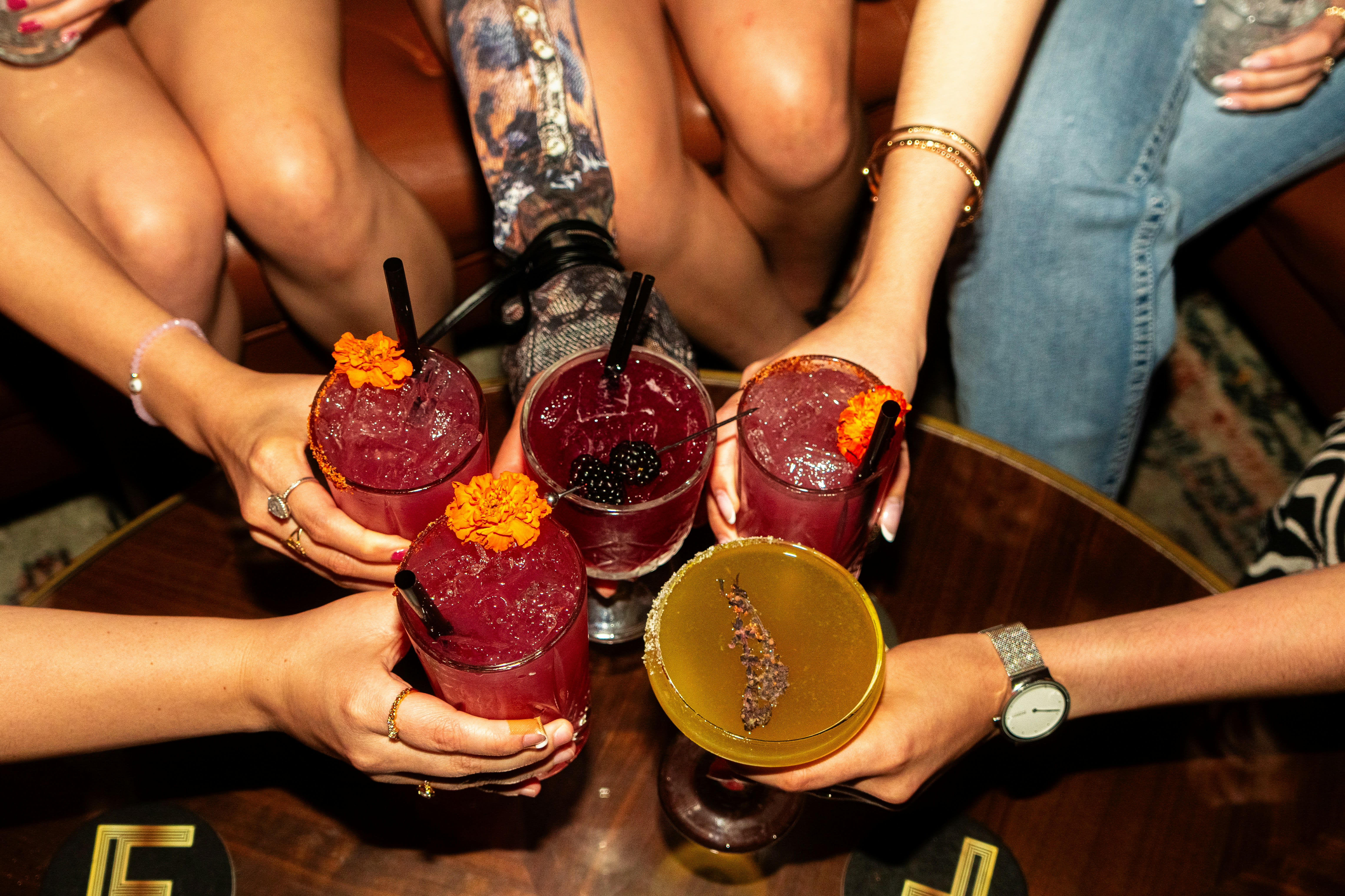 https://unsplash.com/photos/friends-cheers-with-colorful-cocktails-at-a-bar-wWex-z3PefA