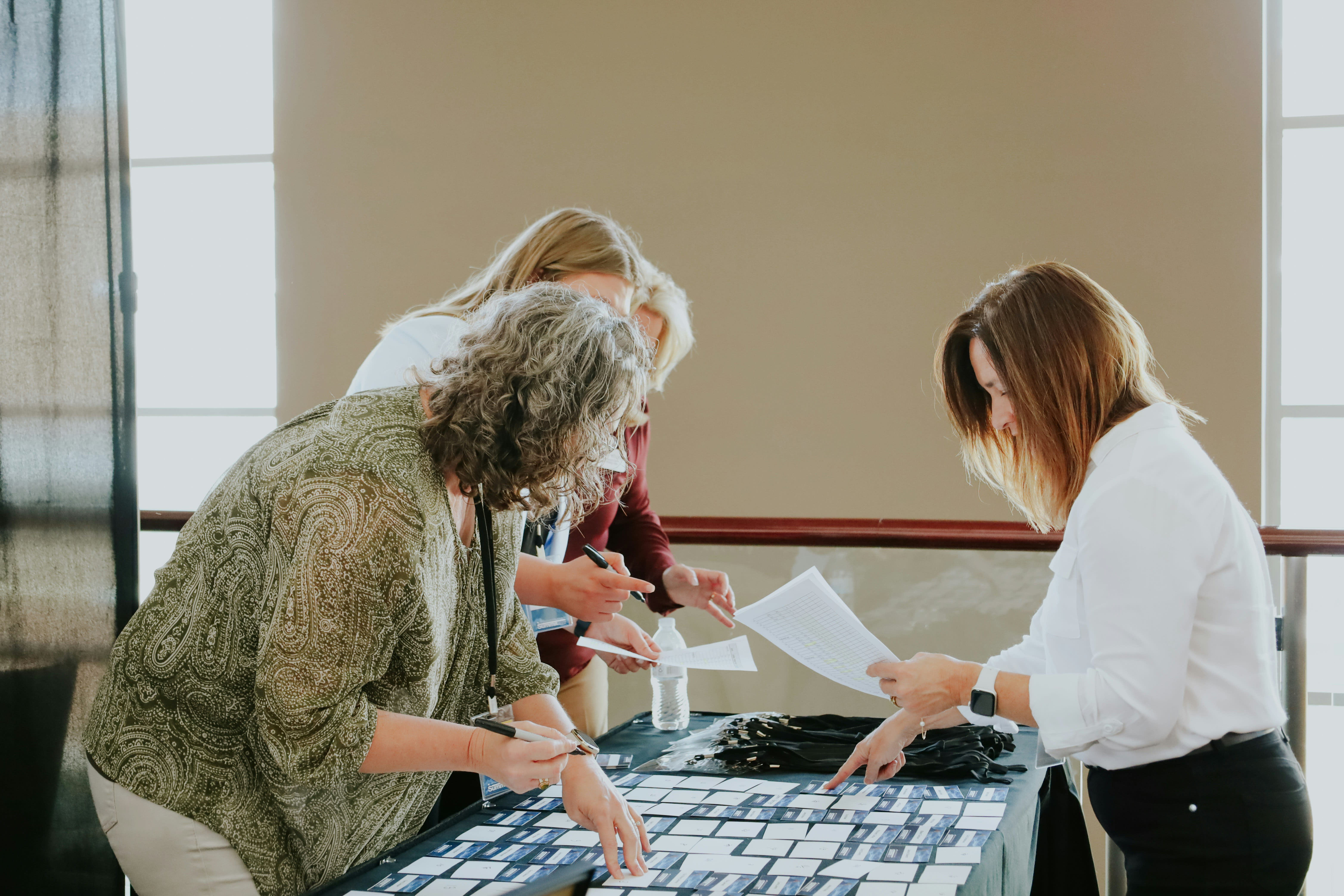 https://unsplash.com/photos/a-group-of-women-standing-around-a-table-with-a-keyboard-A5ygXwg9-x4