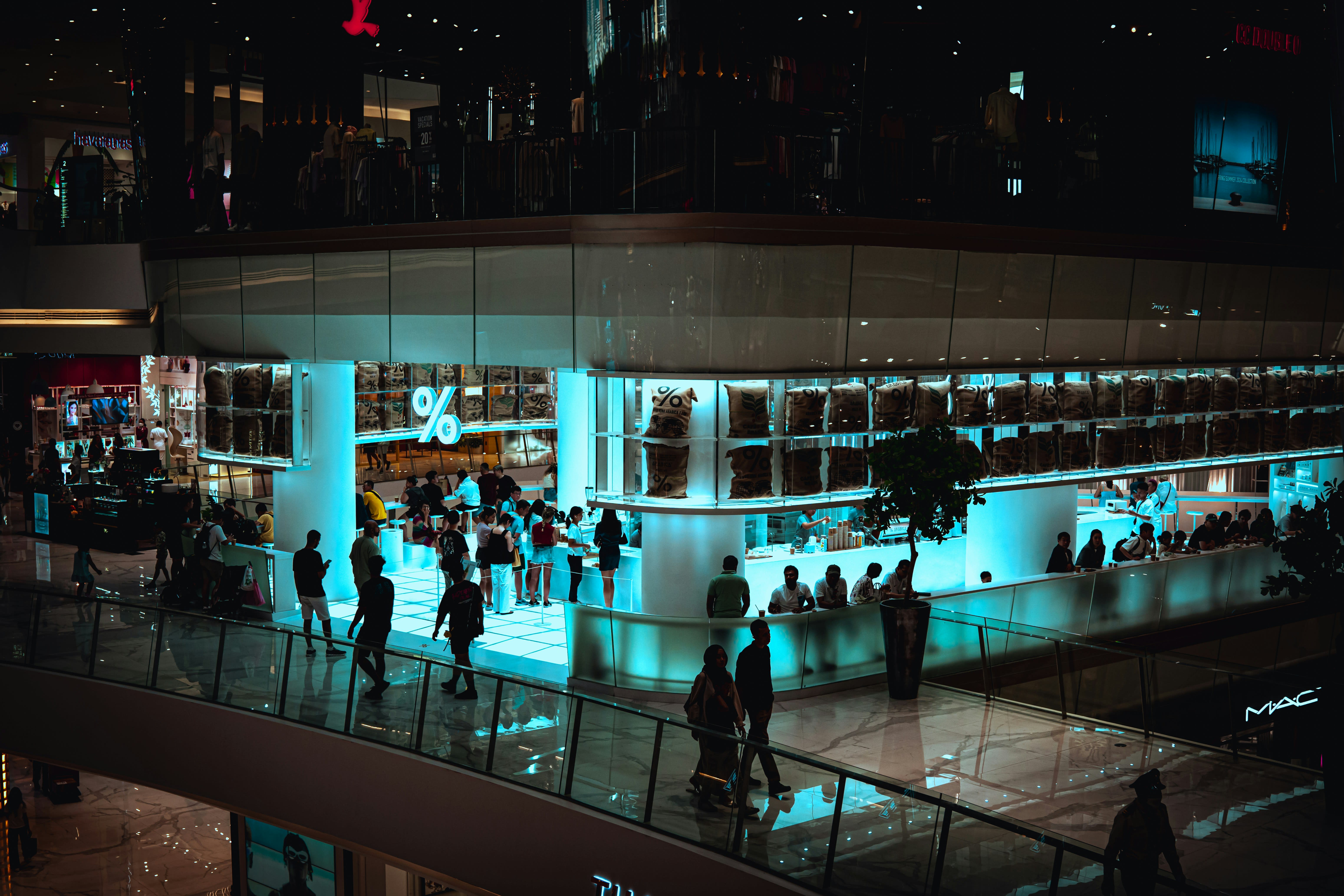 https://unsplash.com/photos/a-group-of-people-walking-around-a-building-at-night-FcX1NQlNays