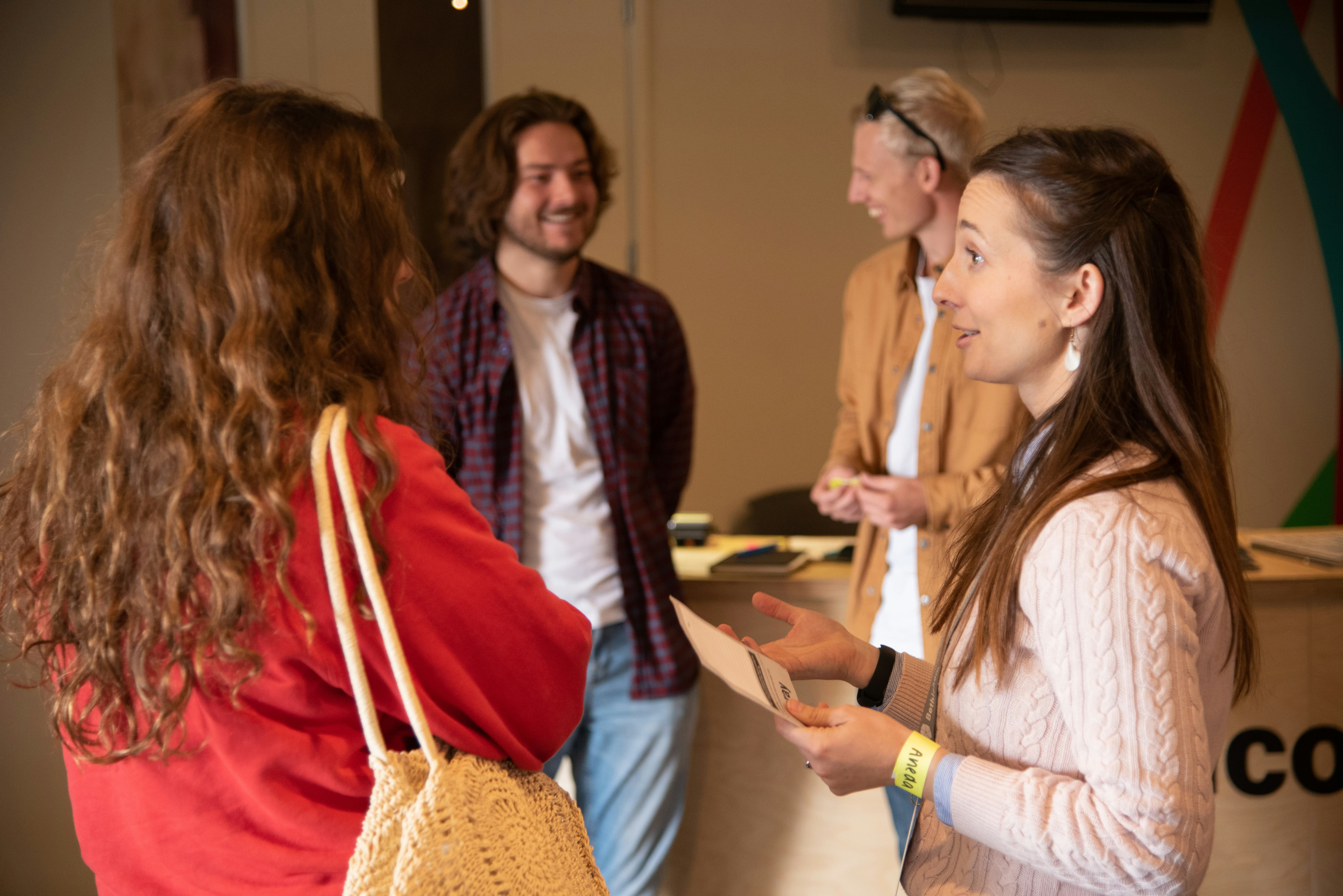 https://unsplash.com/photos/a-group-of-people-standing-around-each-other-zI7Lr4w7z6s