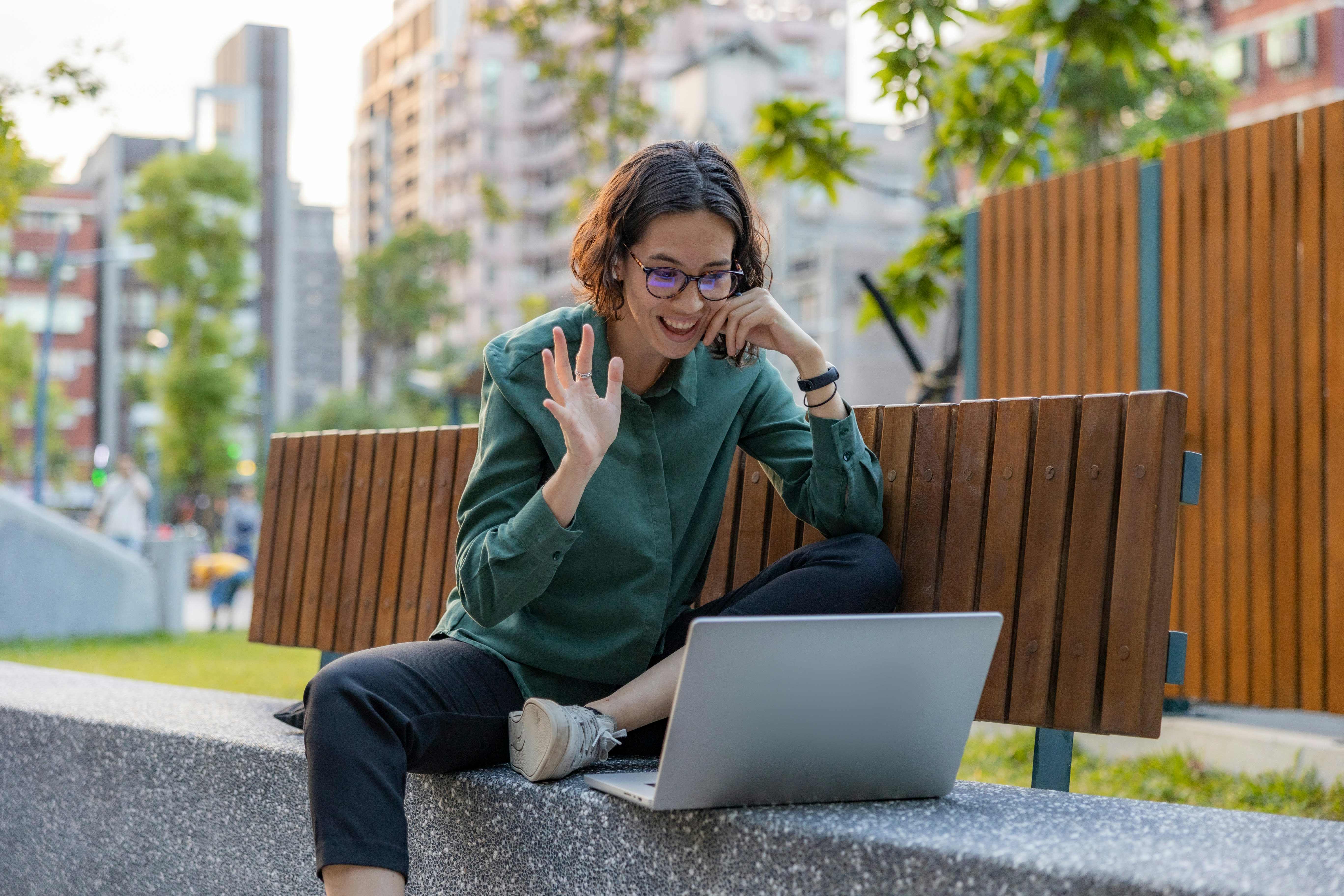 https://unsplash.com/photos/a-woman-sitting-on-a-bench-with-a-laptop-OrTcivPm8RY
