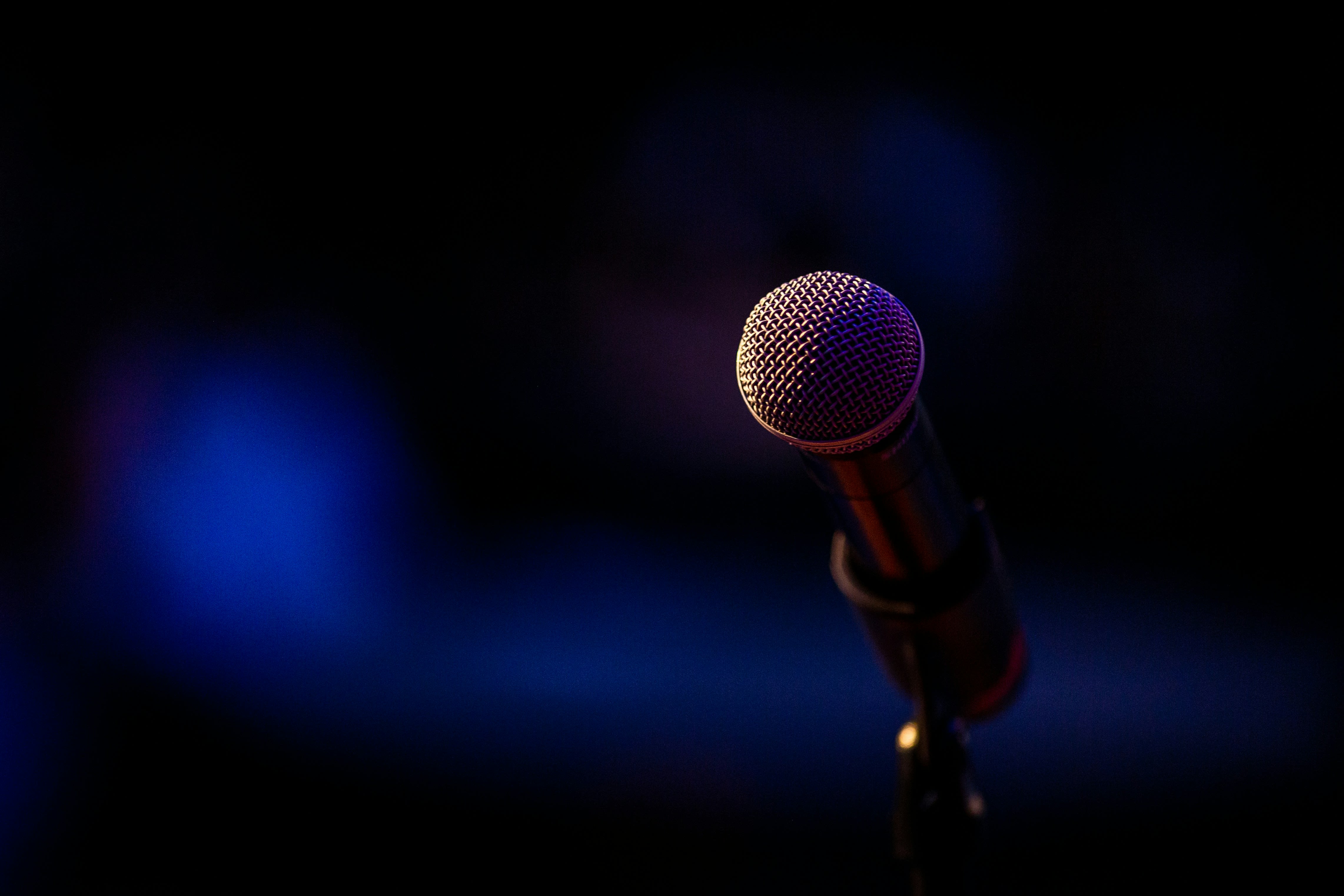 https://unsplash.com/photos/a-microphone-that-is-on-a-stand-in-the-dark-iuklQeAMVB4