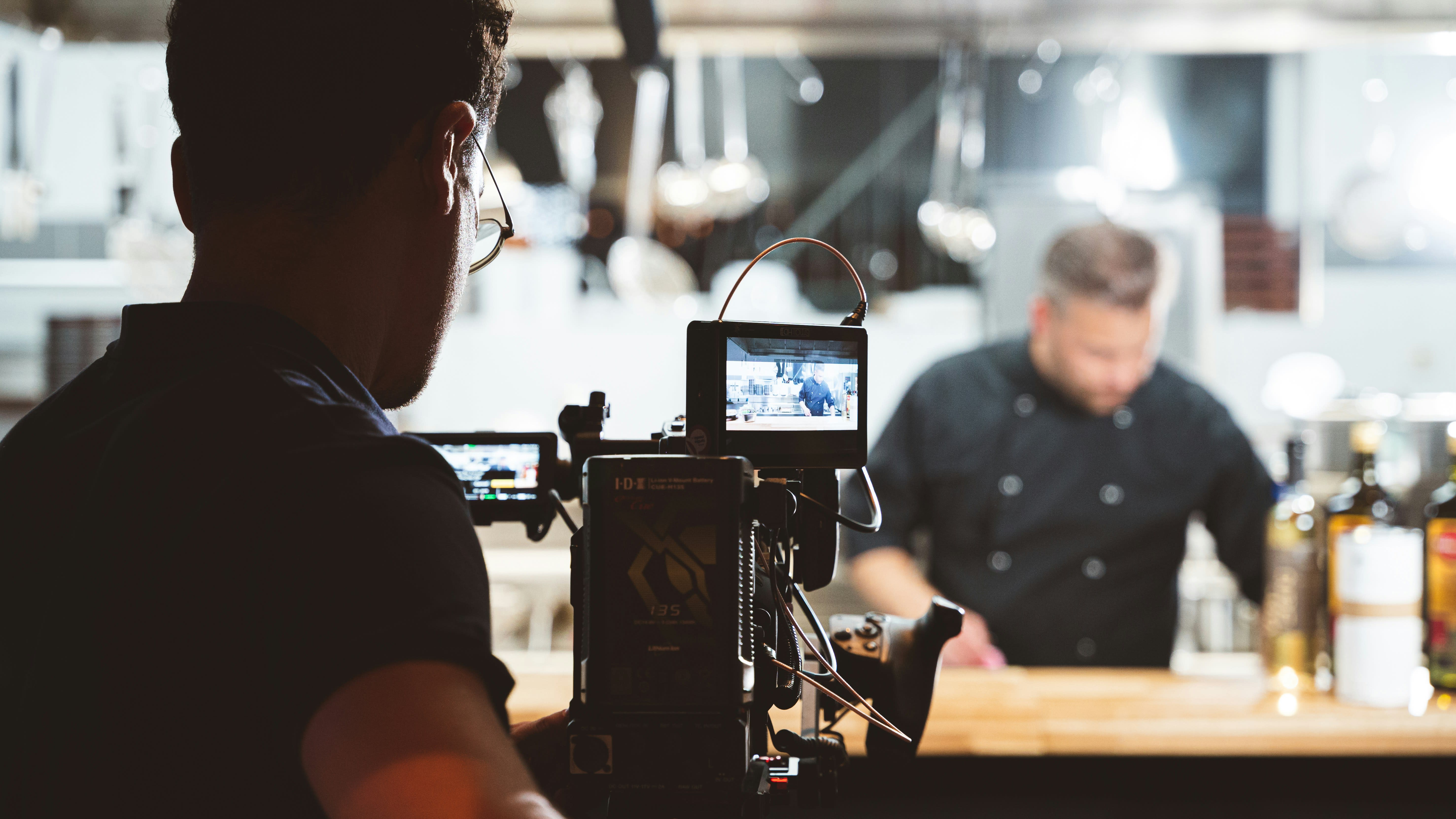 https://unsplash.com/photos/a-camera-set-up-in-front-of-a-man-in-a-black-shirt-0reZtj8eS-c