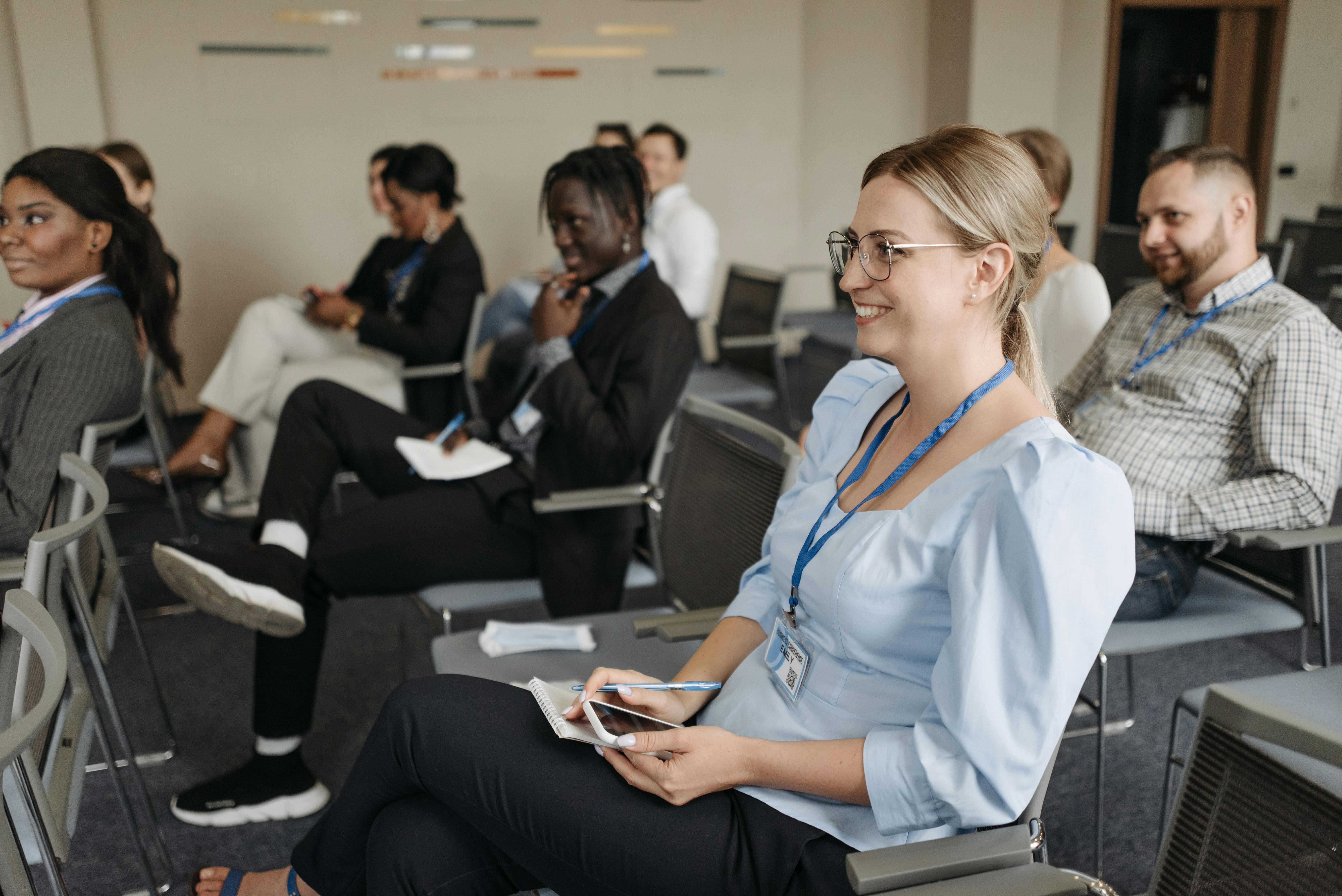 Photo by Pavel Danilyuk: https://www.pexels.com/photo/woman-in-blue-long-sleeve-shirt-sitting-on-gray-chair-smiling-8761322/