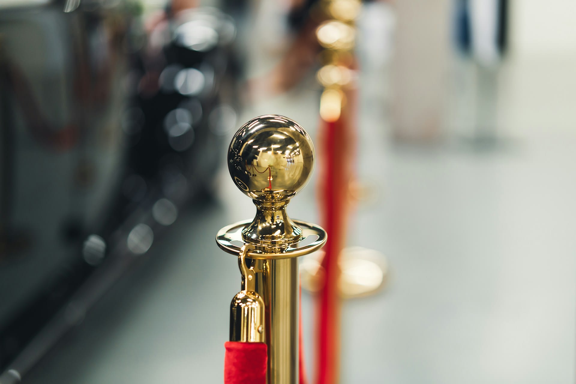 https://unsplash.com/photos/a-row-of-red-and-gold-poles-with-a-golden-ball-on-top-8AHRUprVOk4 Photo by Jakub Żerdzicki on Unsplash
