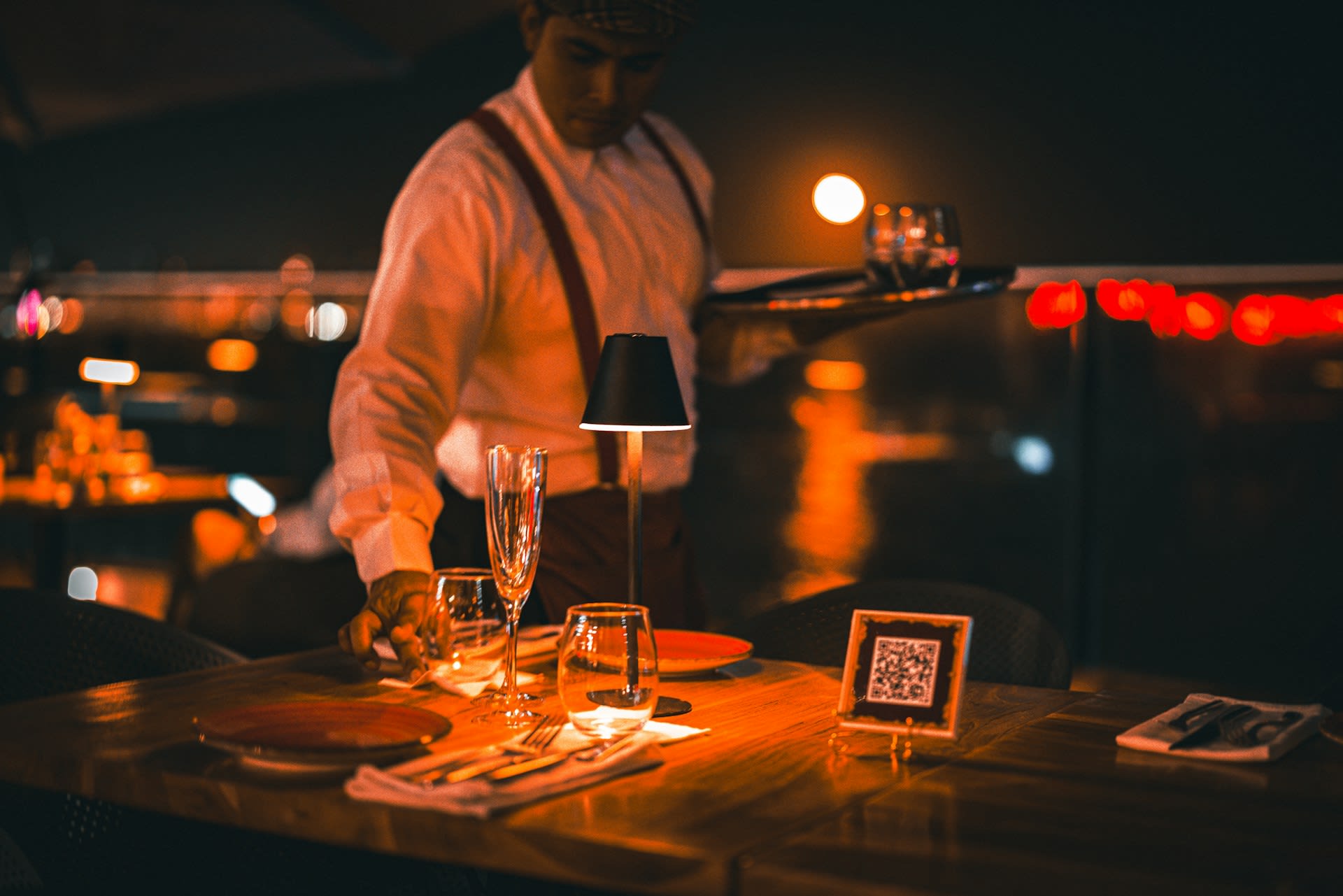 https://unsplash.com/photos/a-man-standing-at-a-table-with-wine-glasses-H5k4VKG43uY Photo by leo Caman on Unsplash