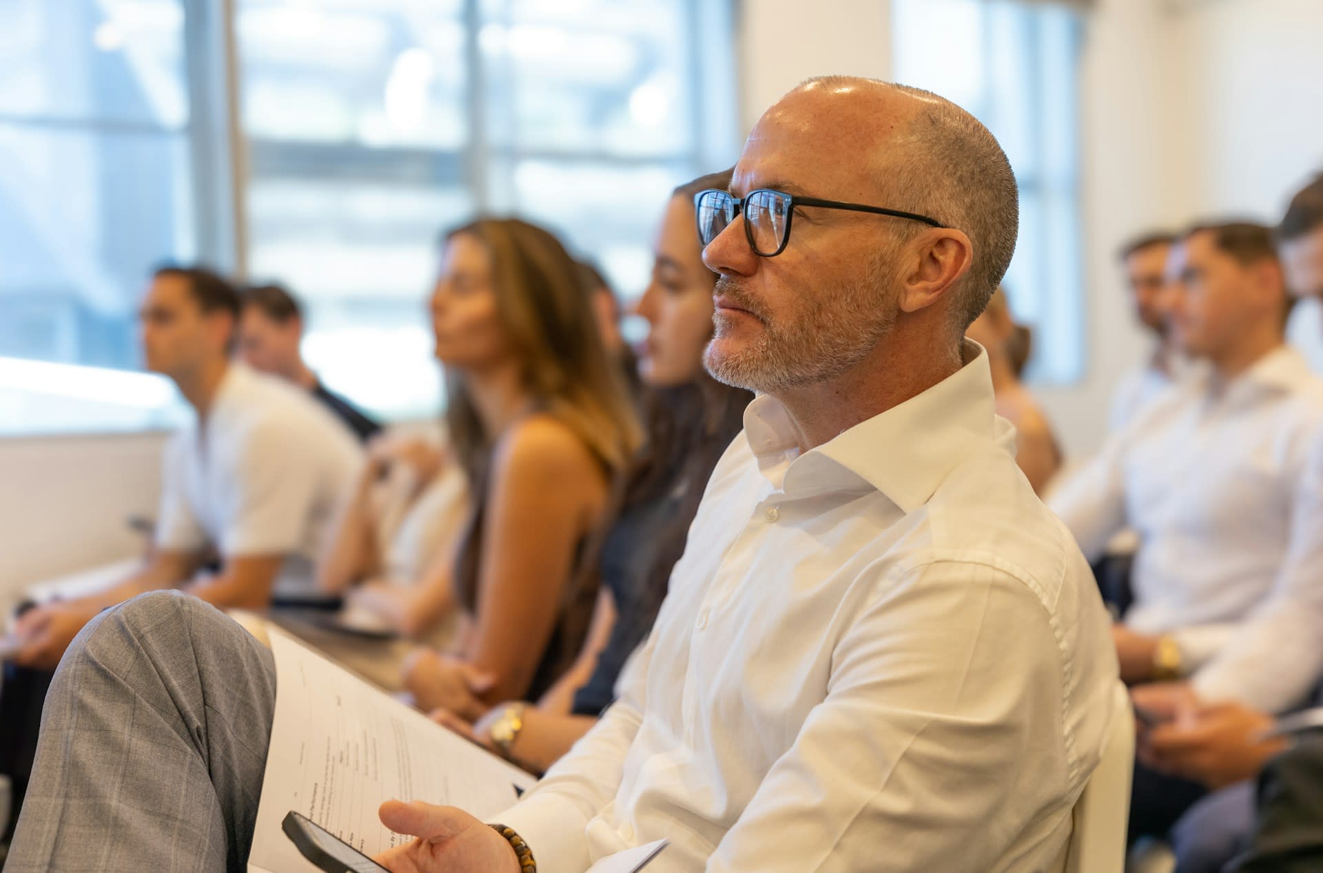 Photo by Macourt Media on Unsplash https://unsplash.com/photos/a-group-of-people-attend-a-business-conference-gvpK54EkbRE