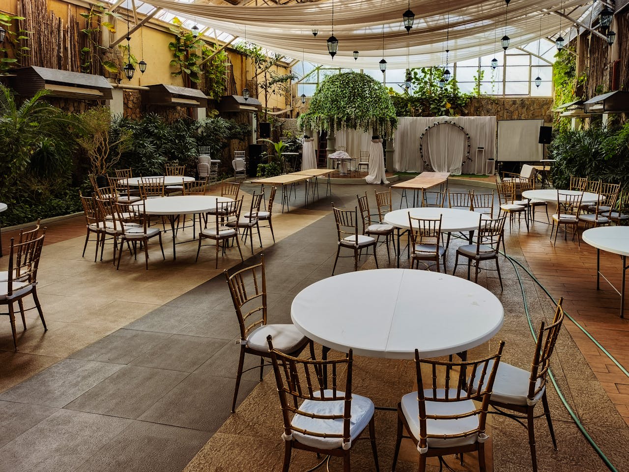 https://www.pexels.com/photo/empty-indoor-wedding-venue-with-round-tables-36151390/