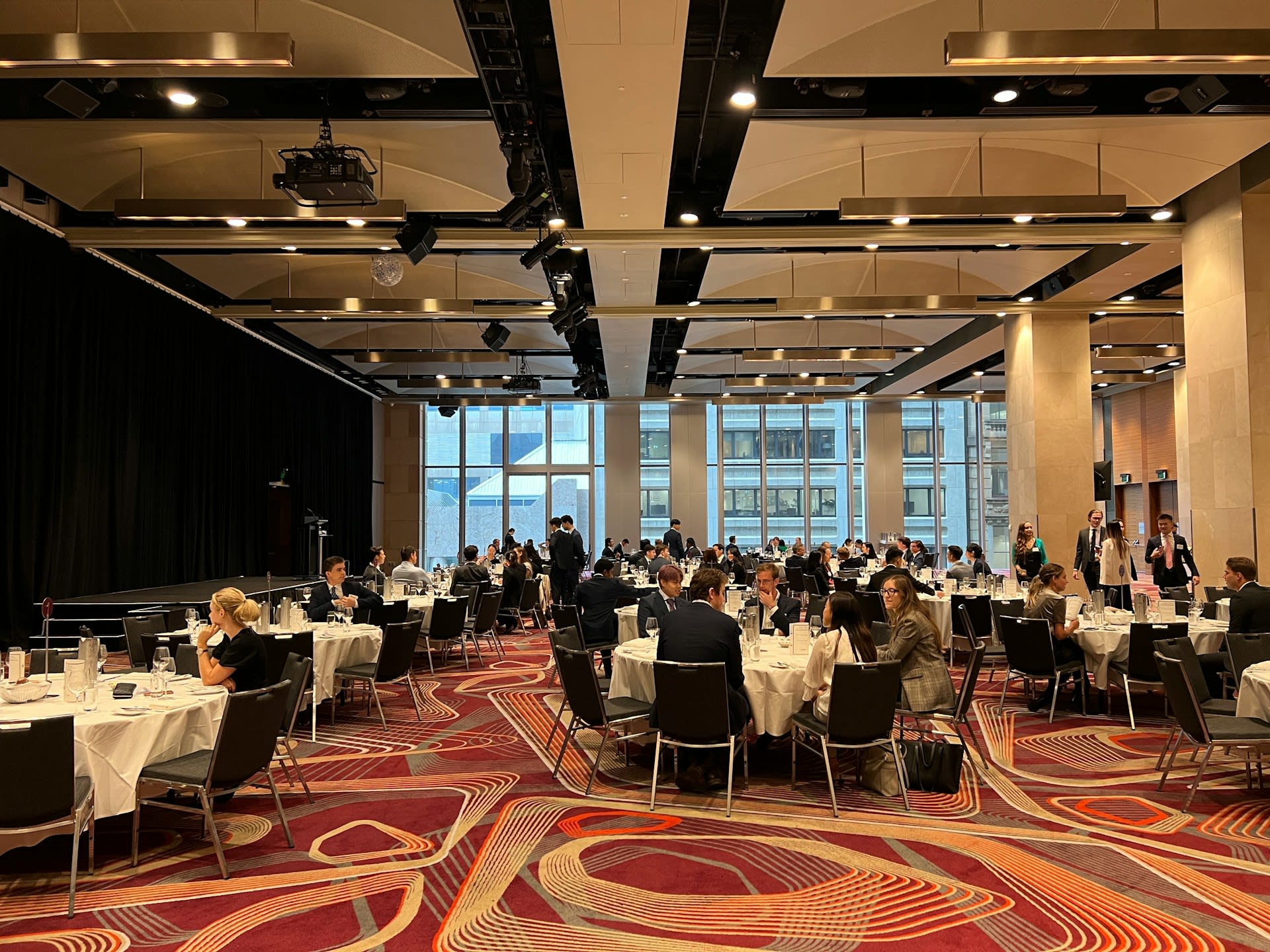 https://unsplash.com/photos/a-group-of-people-sitting-at-tables-dBgC1vL9Cyk