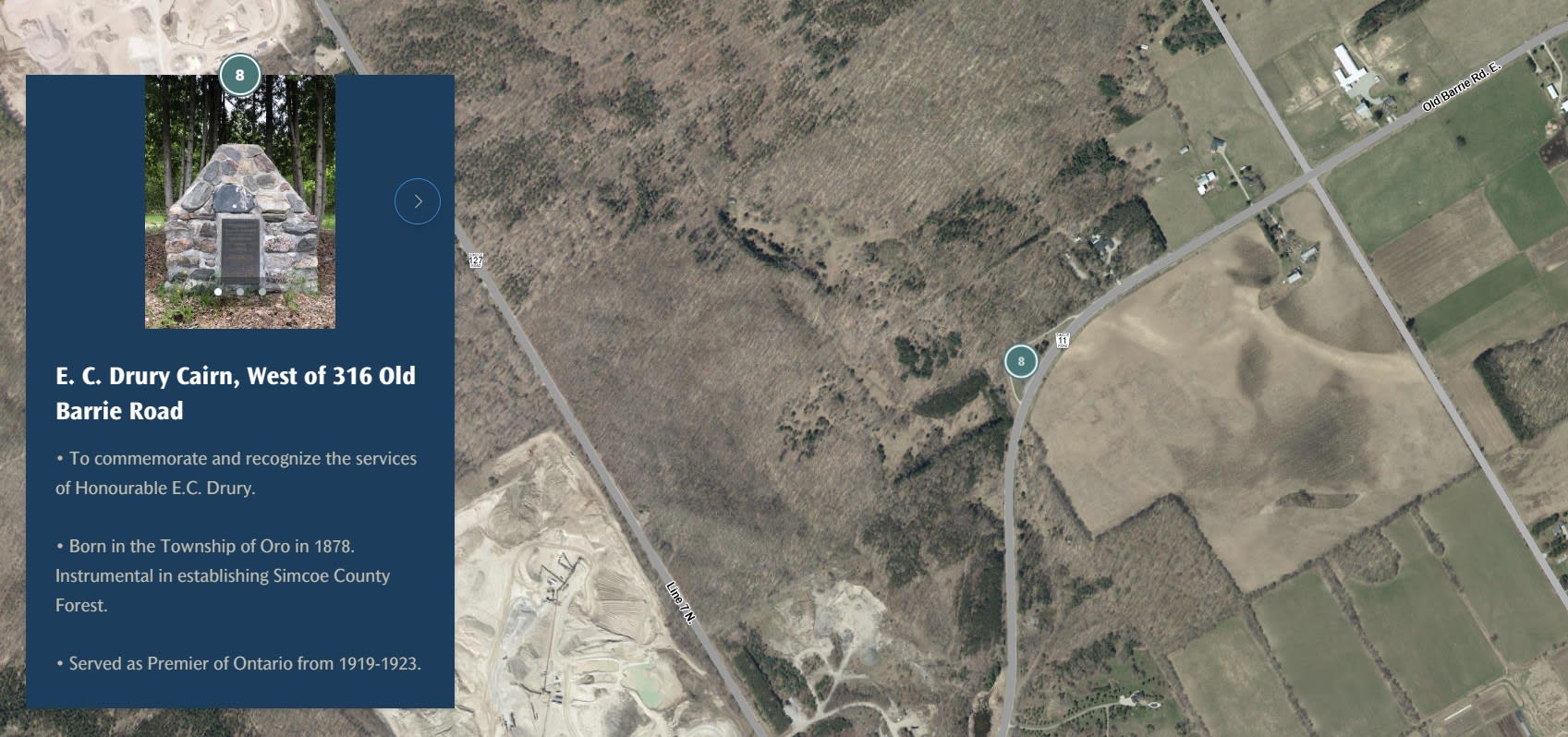 An aerial view of a field with an image and writeup of E.C. Drury Cairn.