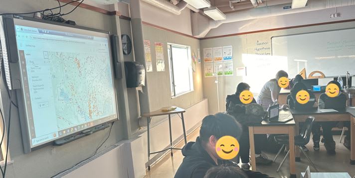 An image of a class of high school students working on an ArcGIS activity on their laptops.
