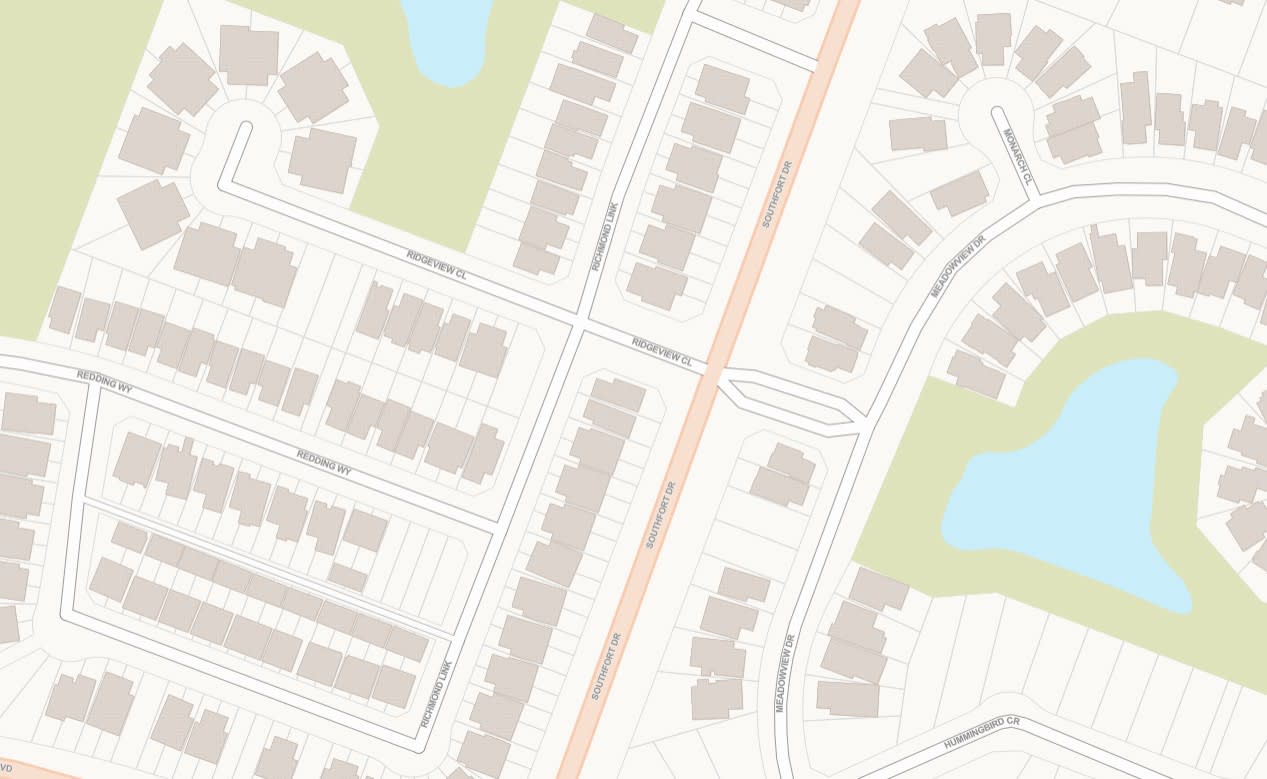 Un fond de carte simplifié avec une palette de couleurs à faible saturation montrant les empreintes de bâtiments, les parcelles, les routes, les plans d’eau et les parcs.