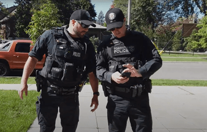 Officers reviewing dashboard data together during a field check