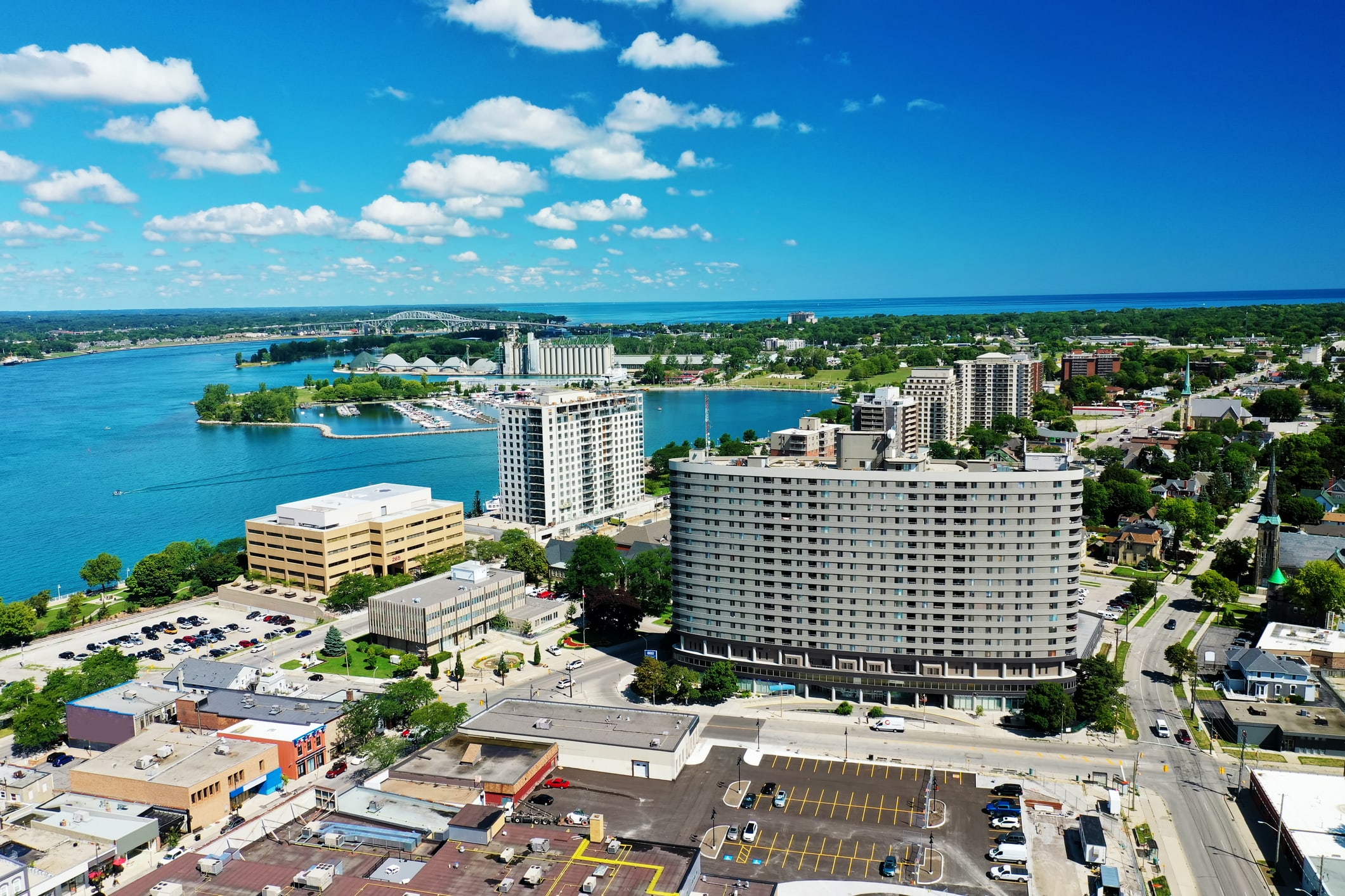 An aerial photo of Sarnia, Ontario, a city of 75,000 residents in southwestern Ontario, that shows the city’s downtown area, Sarnia Bay and Sarnia Harbour as well as the Blue Water Bridge in the distance.
