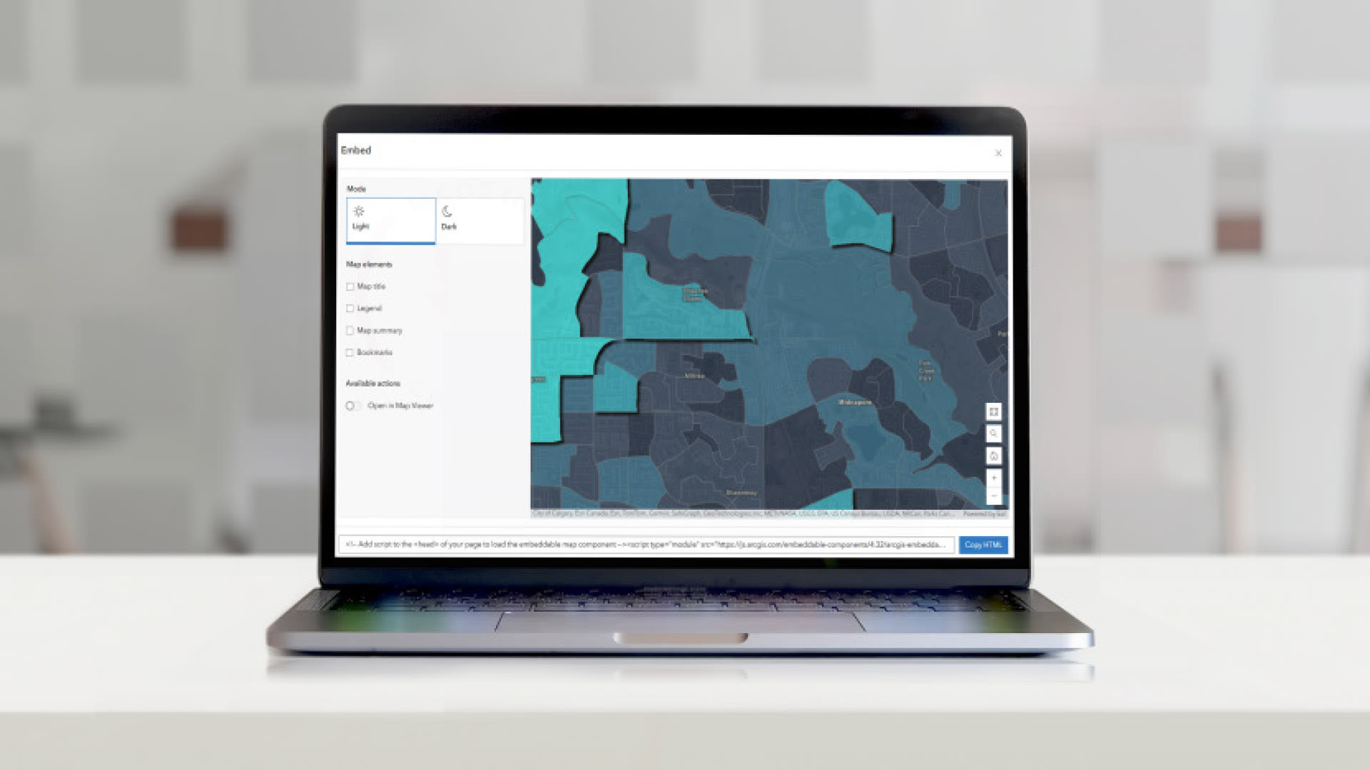 A laptop on a flat surface that shows the Embed tool in Portal for ArcGIS.