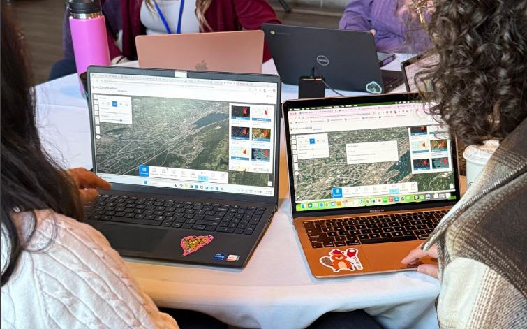 Teachers sitting in front of their laptops working on an activity in ArcCanada Atlas.