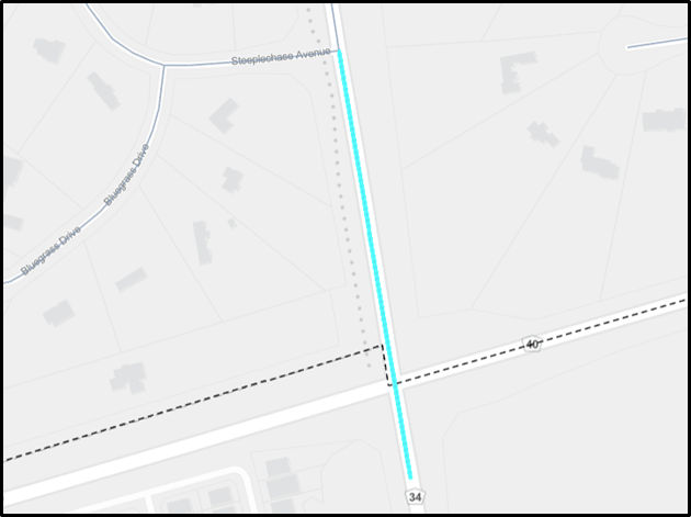 Map showing a highlighted road segment in light blue crossing a dashed municipal boundary line.