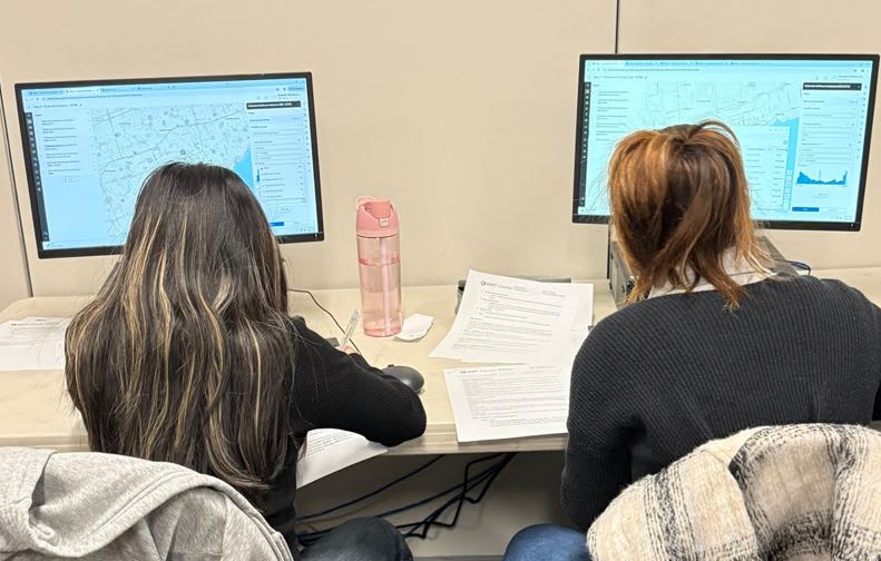 Two female students working at their computer screens.