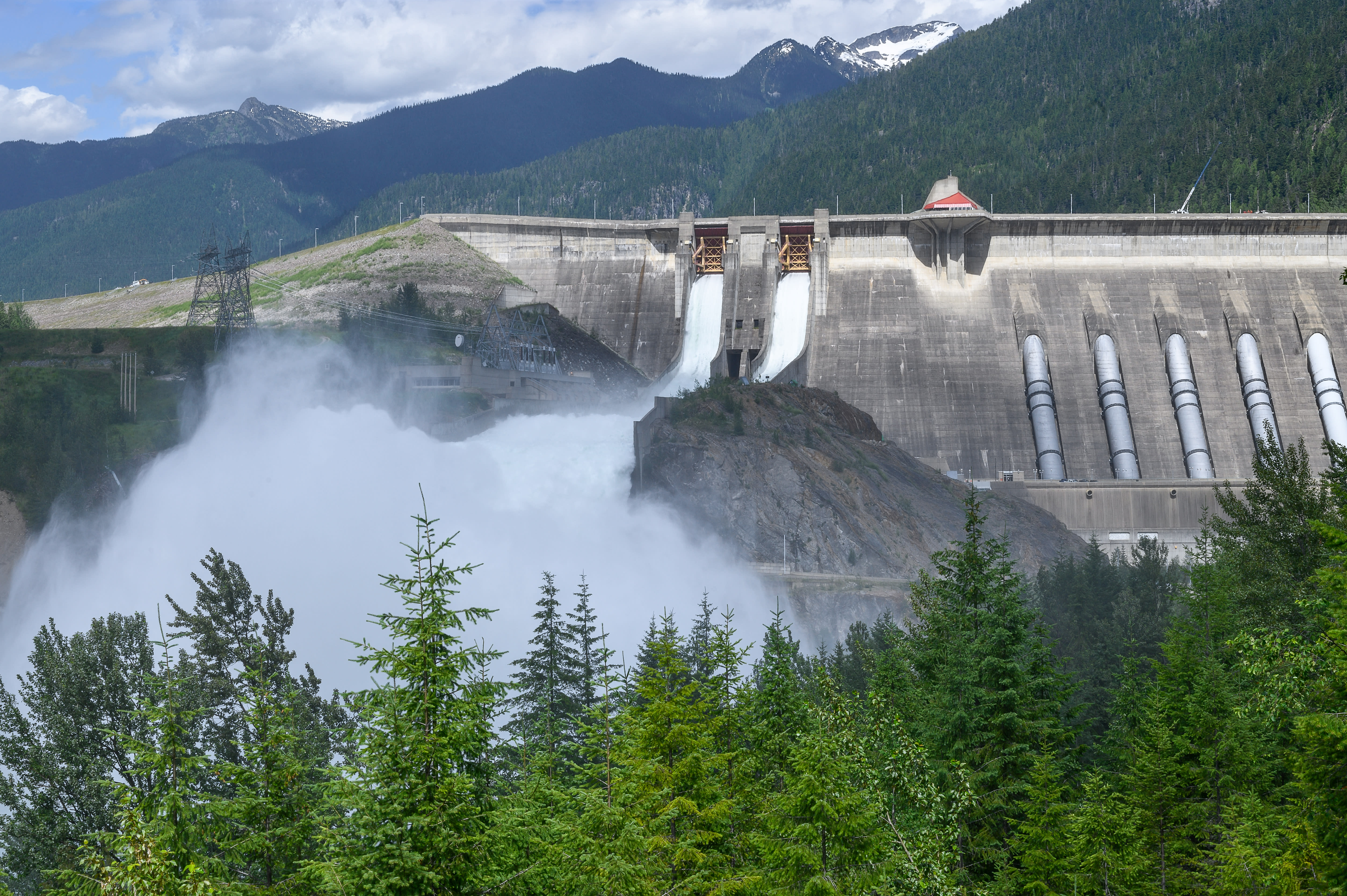 Large hydroelectric dam in a mountainous landscape representing complex infrastructure operations.