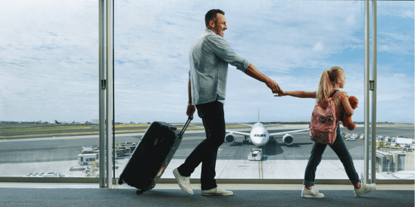 father traveling with daughter in airport