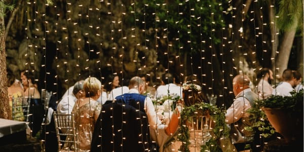 guests at wedding reception with twinkle lights