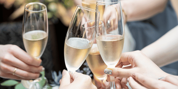 guests clinking champagne glasses at wedding for wedding toast