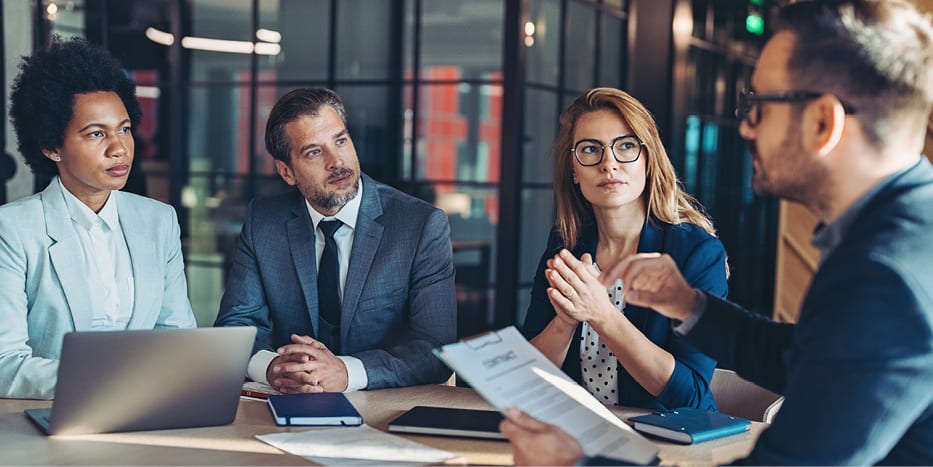 Group of professionals talking at a meeting table