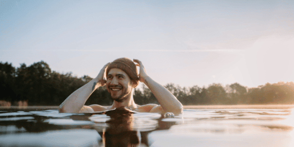 man cold plunging in lake