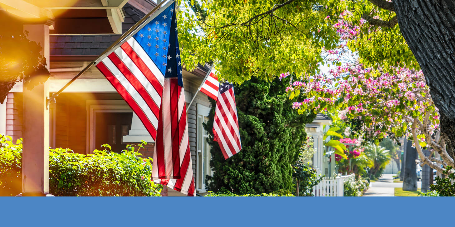 Neighborhood displaying American flags on houses