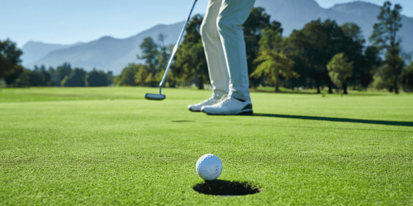 closeup of person swinging golf club