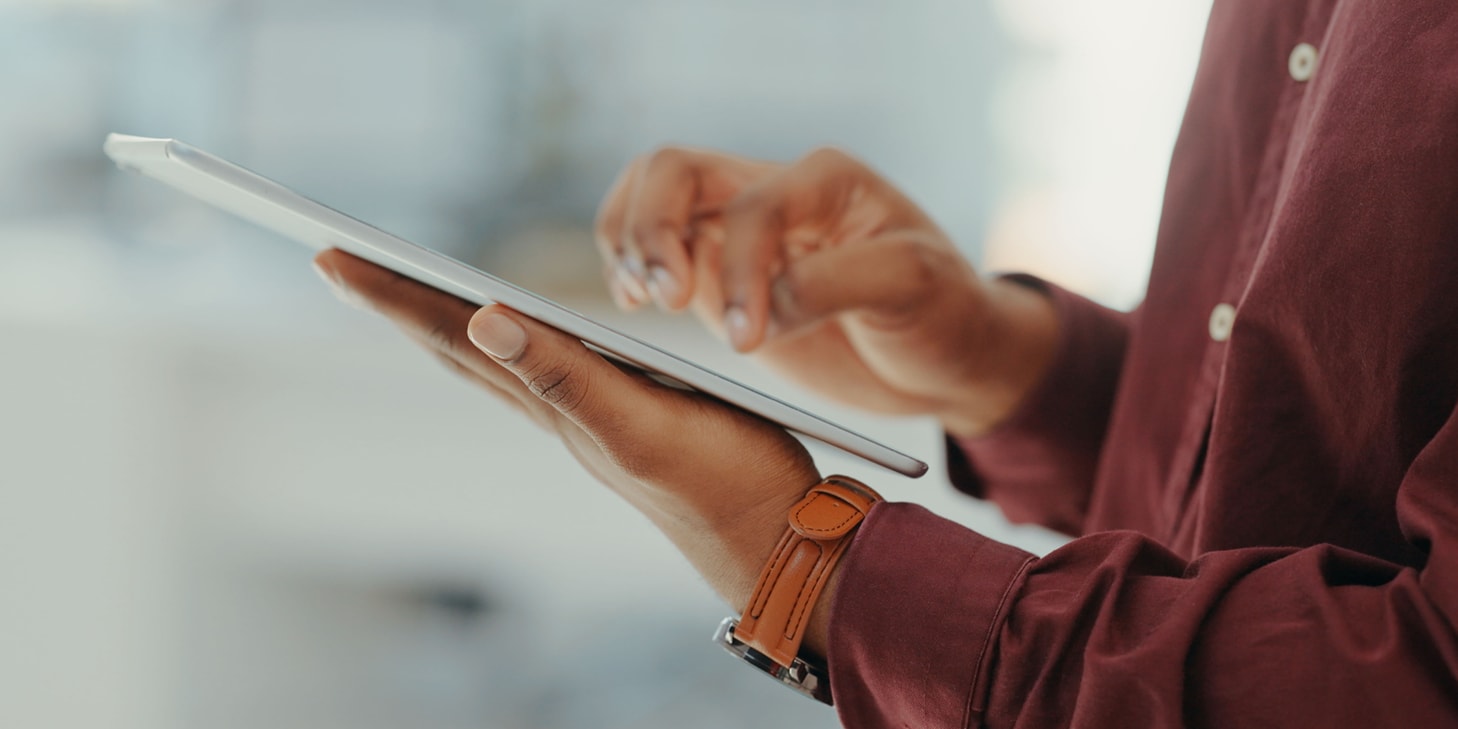 Hand typing on a tablet