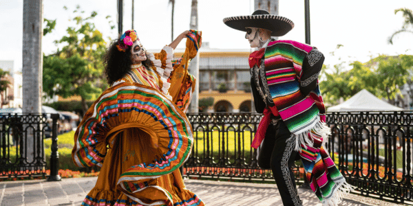 couple dressed up and dancing to celebrate day of the dead