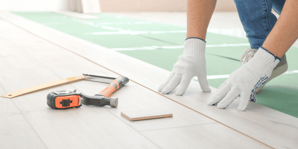 person installing laminate flooring