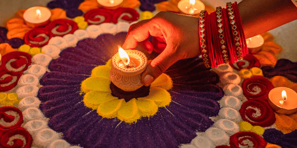 woman lighting candle for Diwali
