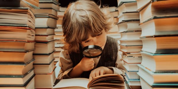 young child reading mystery book