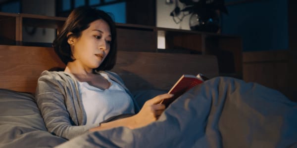 adult woman reading mystery book