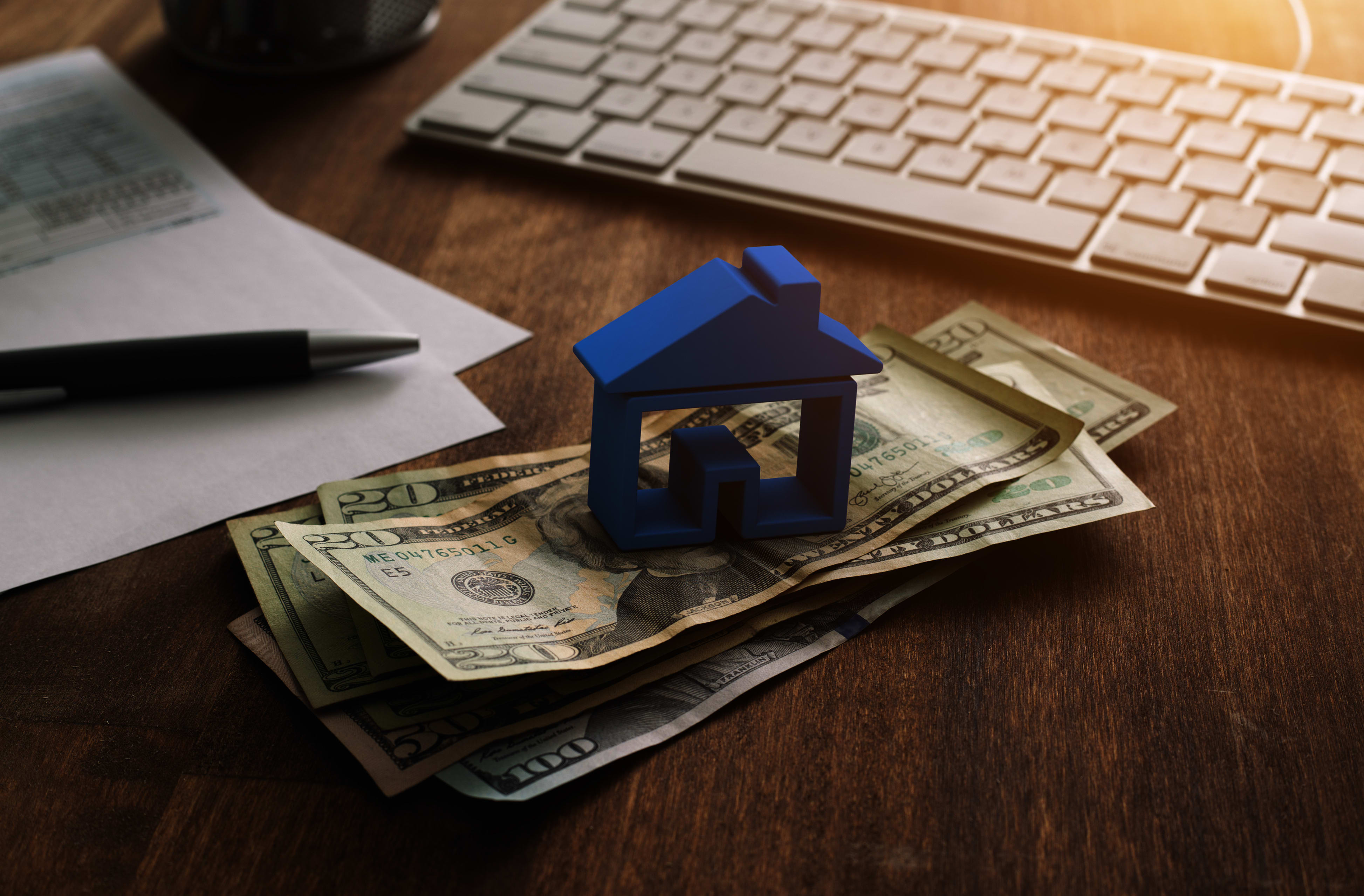 house on top of bill of money