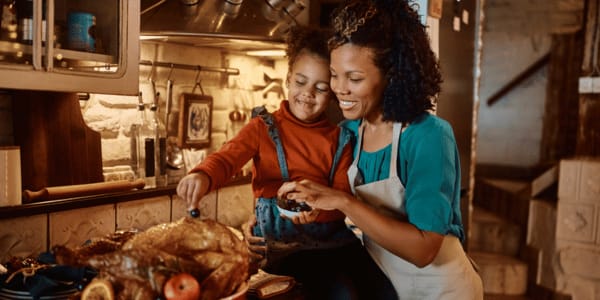 mother and daughter cooking in kitchen for holiday party