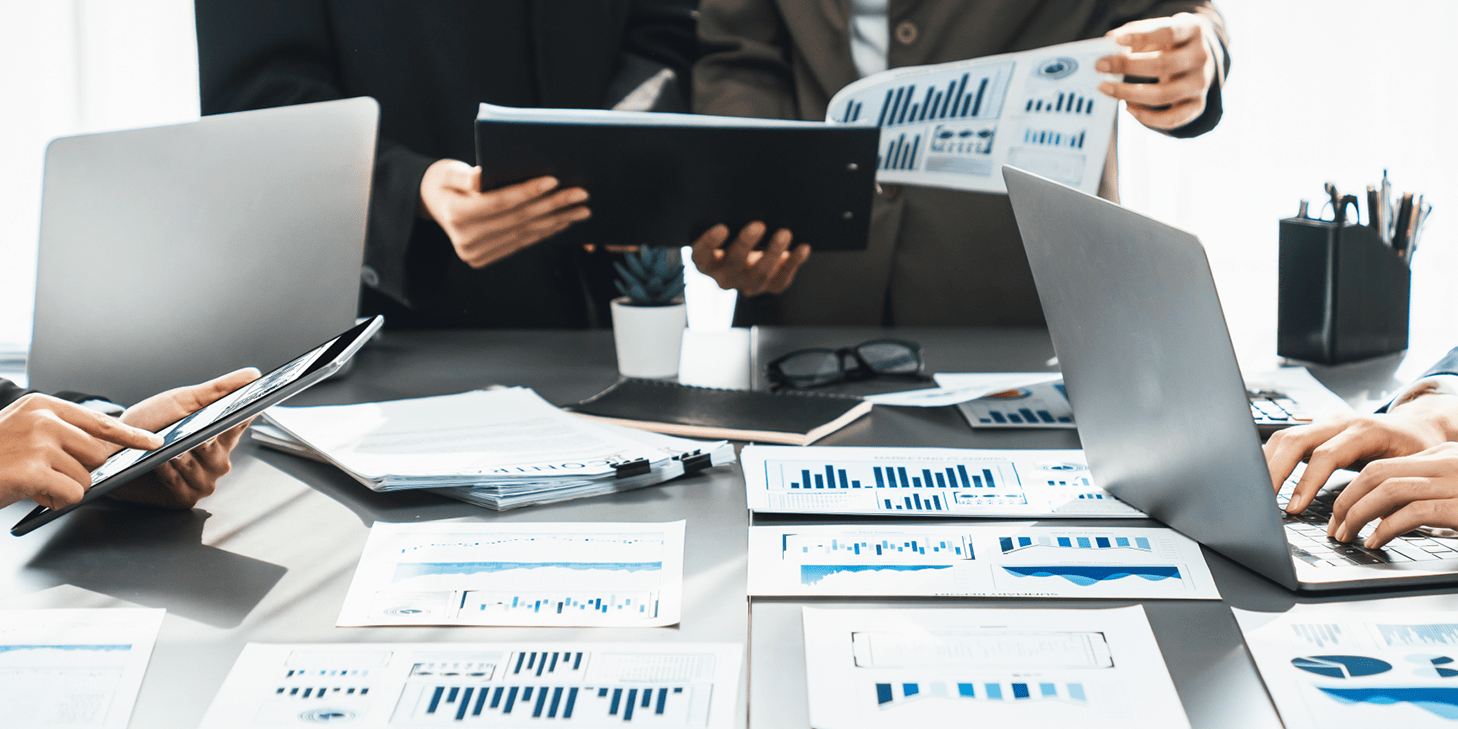 Meeting table with paper graphs spread around