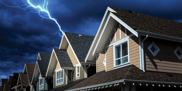 lighting bolt striking home roof during storm