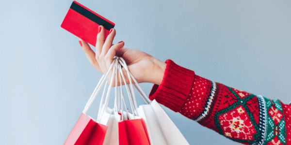 Close up crooped shot of woman hand holding many paper handbags and red credit card stock photo