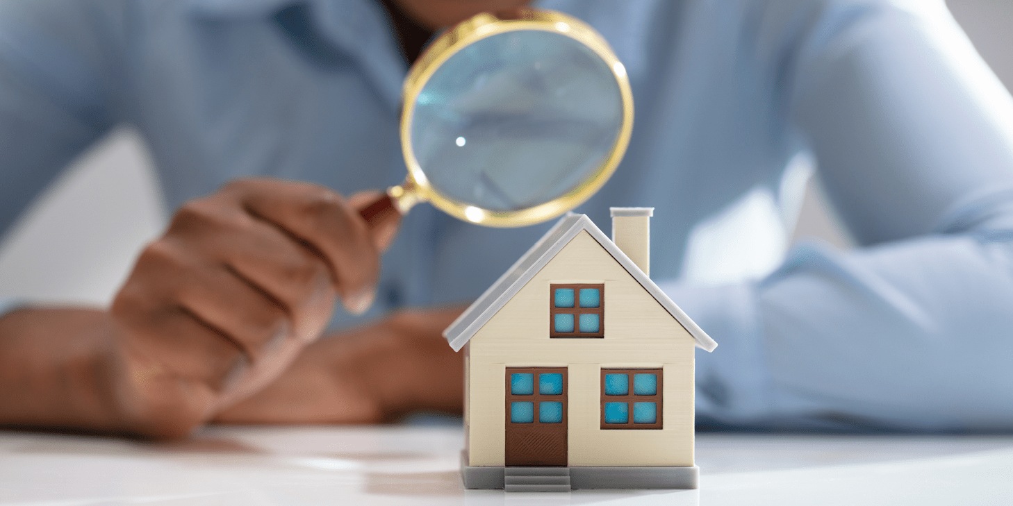 magnifying glass over a toy house