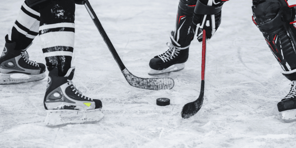 two ice hockey players playing ice hockey