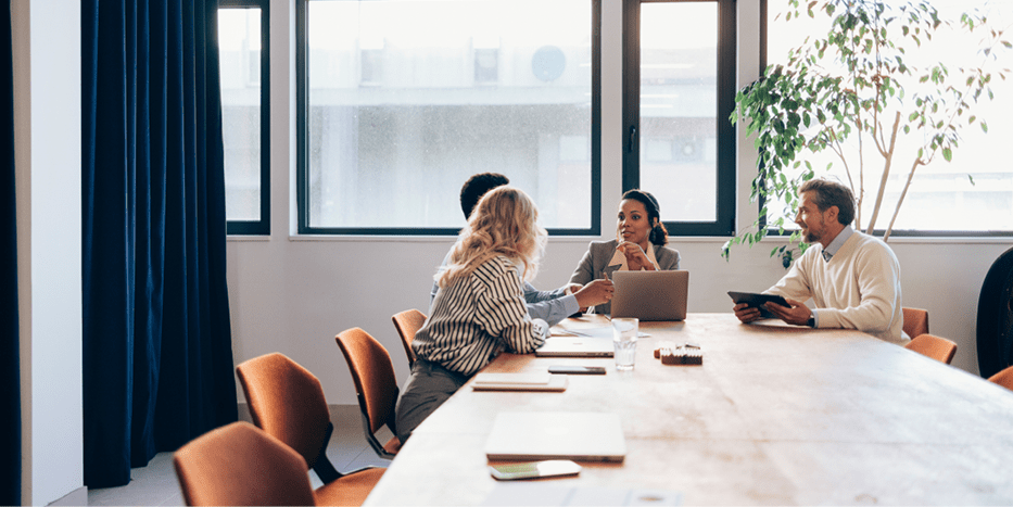 People meeting in a meeting room with large windows
