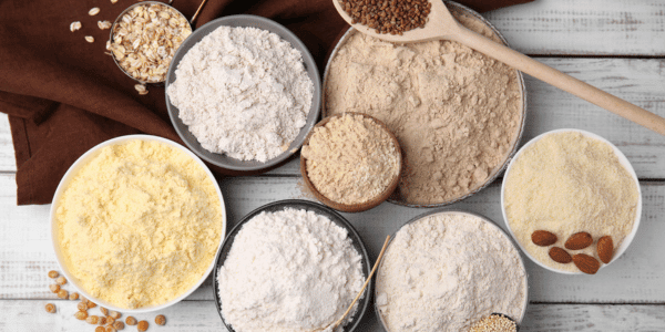 different types of flour in bowls on table