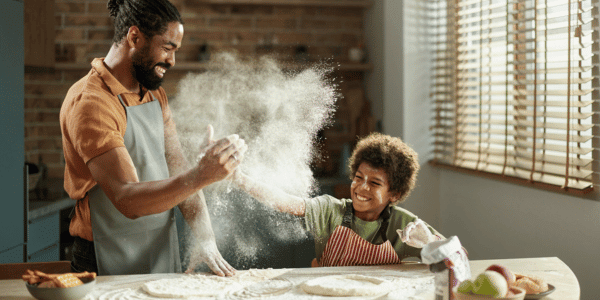 father and son playing with different types of flour