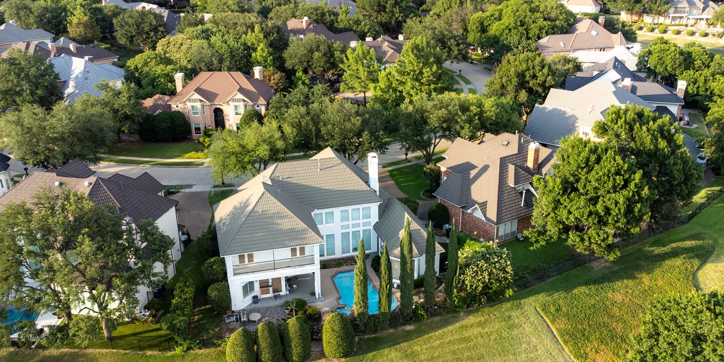 Suburban community with large homes and trees.