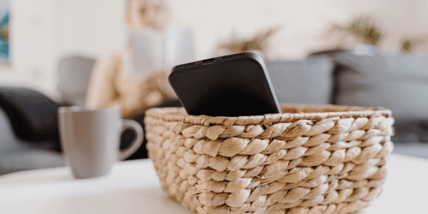 woman reading book with phone in basket on digital detox