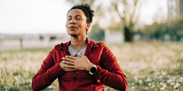 woman taking deep breaths and meditating 